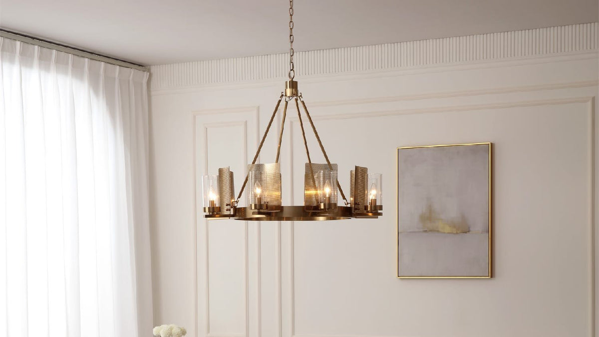 Brass eight-light VidaLite Aurelia chandelier lit above a living room, shown against a paneled wall