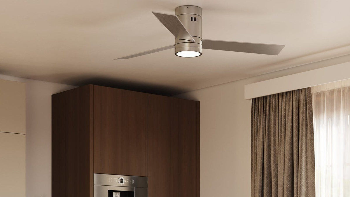 A brushed nickel ceiling fan with an integrated LED light kit, centered on a warm dining room ceiling