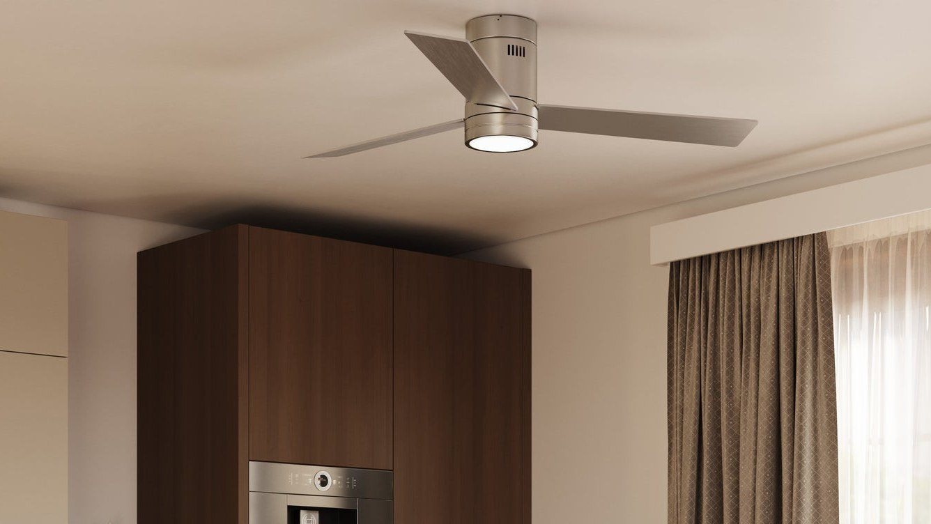 A brushed nickel ceiling fan with an integrated LED light kit, centered on a warm dining room ceiling