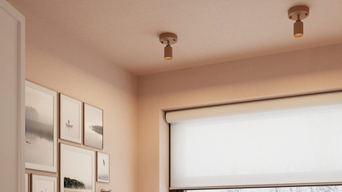 Two ceiling-mounted Shura spot light fixtures lit above a vanity by a bright window