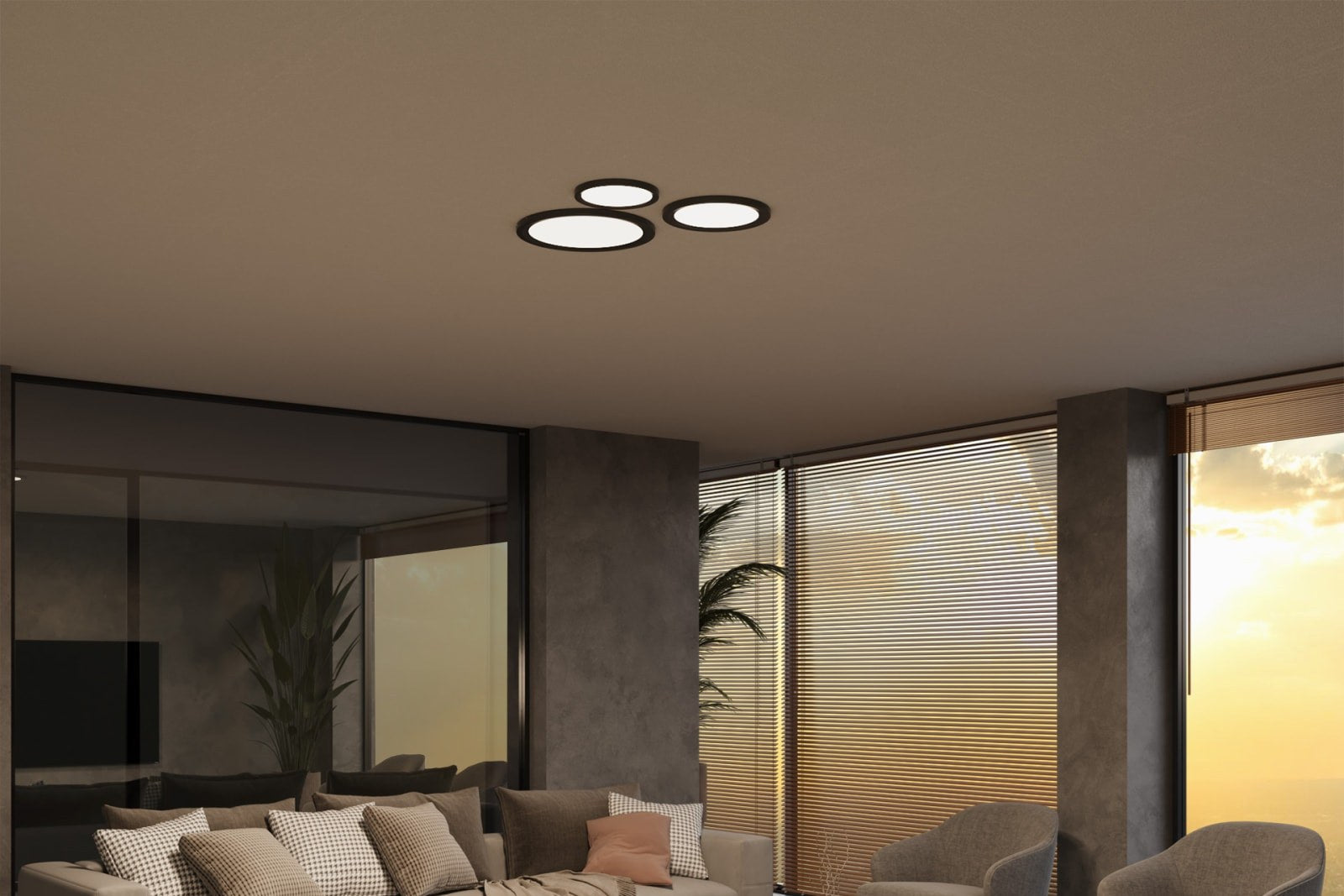 Three black Slim Surface flush mount discs grouped on a flat living room ceiling at dusk