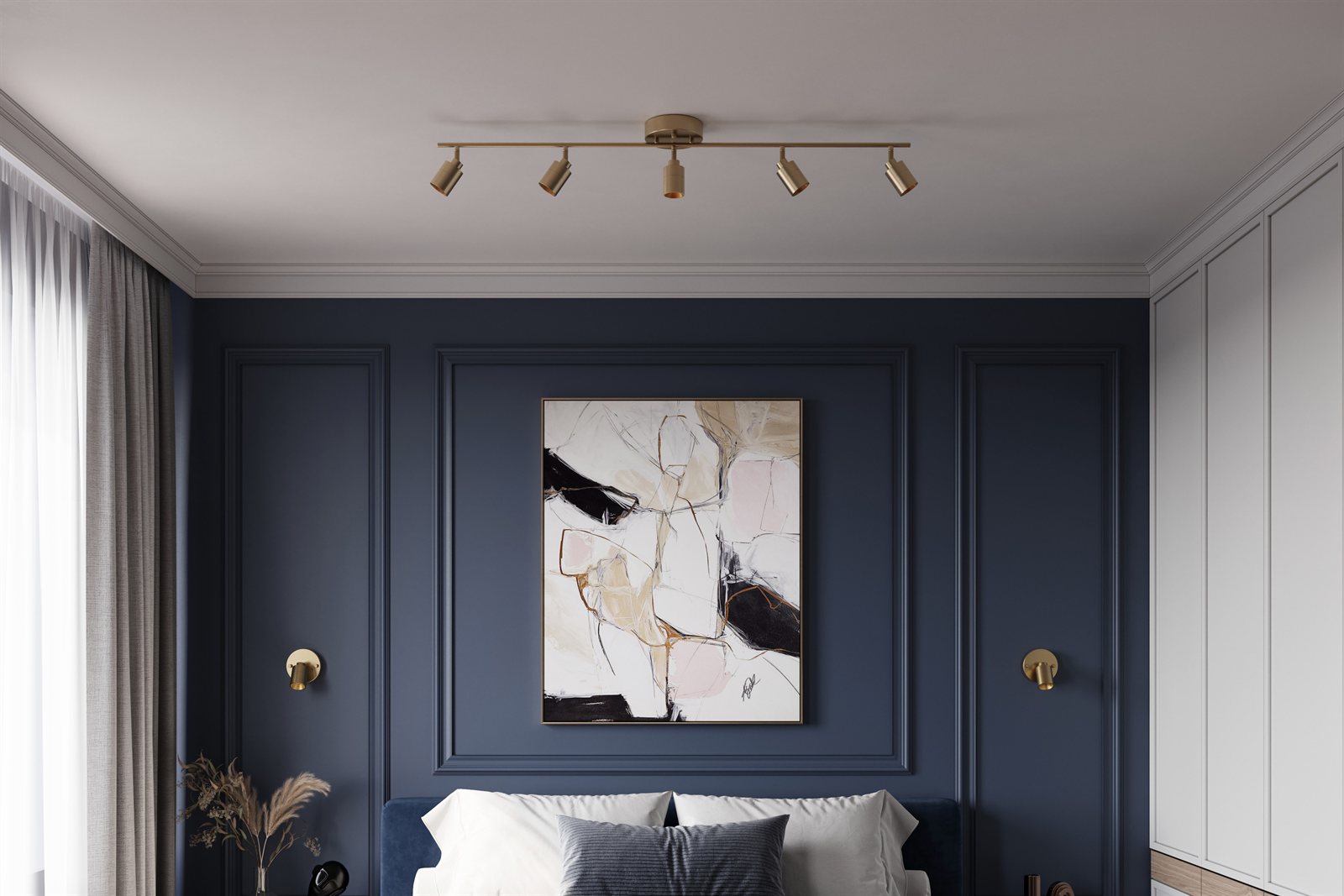 A brushed brass Shura track light over a bed in a navy-walled bedroom, the heads aimed at the artwork above the headboard
